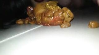 A person takes a massive shit on a plate and then plays with it