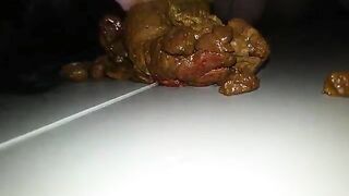 A person takes a massive shit on a plate and then plays with it