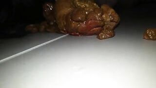 A person takes a massive shit on a plate and then plays with it