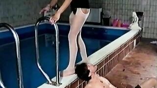 Woman takes a shit on a man's face in the pool