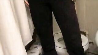 Woman squats over a toilet with her skirt up