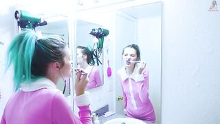 Girl brushes her teeth in the mirror