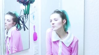 Girl brushes her teeth in the mirror