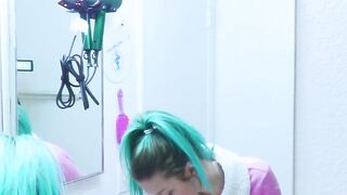 Girl brushes her teeth in the mirror