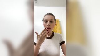 Woman pisses into her hand in the bathroom