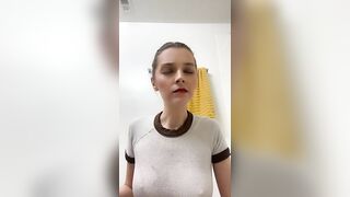 Woman pisses into her hand in the bathroom