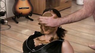 Woman licks shit from a cock in her face
