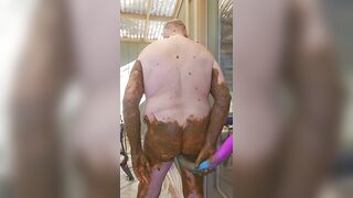 Man with a lot of shit on him cleans it off with a dildo