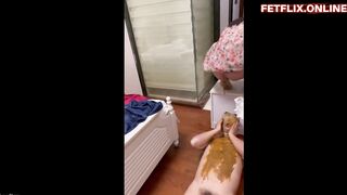 Woman shits on a doll in the bathroom
