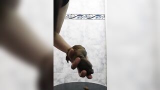 Messy woman pulls a huge shit out of her ass with her hand