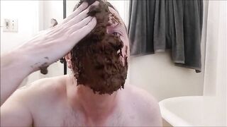 Man covers his head and face with shit