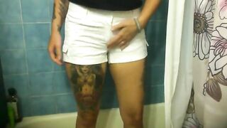 Girl takes down her white shorts and bends over in the bathroom