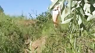 Bitch squats down to shit outside in the woods