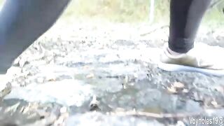 Woman takes a shit and pisses on a rock outside