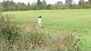 Girl squats and pisses in the grass