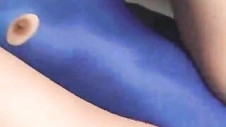 Girl in blue dress lays down while another girl pulls apart her ass with her fingers