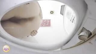 Girl takes a shit in the toilet while sitting on top of it wearing a dress