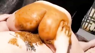 Woman spreads ass cheeks with hands and gets shit played with