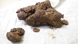 Girl mixes shit and cum on a table