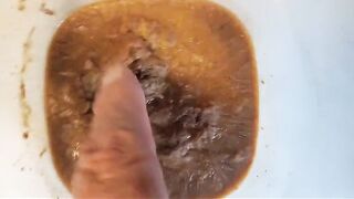 Babe digs in a bowl of shit and piss
