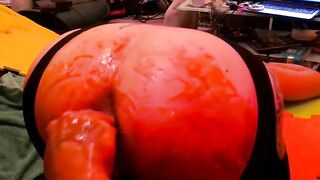 Babe squeezes a giant fake ass with her pussy lips