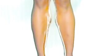 Blonde woman pisses down her legs in the shower