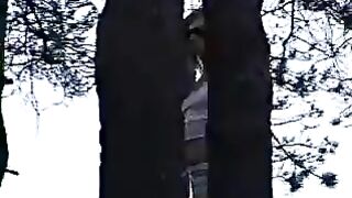 Brunette in woods pulls down shorts and pisses on the ground outside