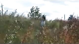 Girl squats to take a shit on the dirt outside