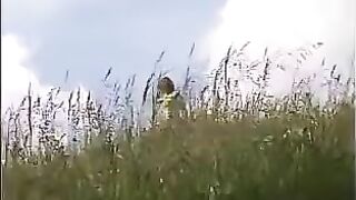 Girl squats and shits on a rock outdoors