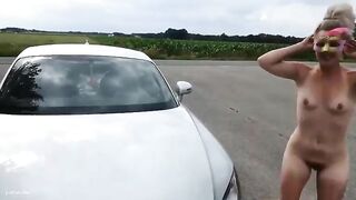 Woman squatting on car hood, spreading her ass open, showing her asshole