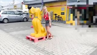 Woman takes a shit on a white blanket in a store