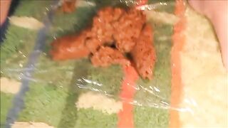 Woman squeezes massive shit out of her ass into a plastic bag