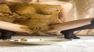 Blonde eats shit from plate on the bed