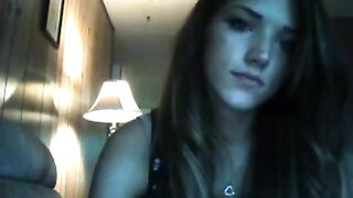 Brunette plays with her ass while sitting on the couch