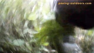 Woman pisses on a tree in the woods