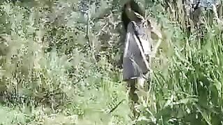 Naked woman takes a shit by the lake