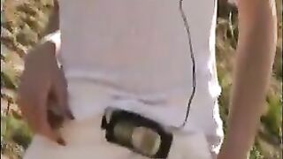Girl takes a shit on a rock in the dirt