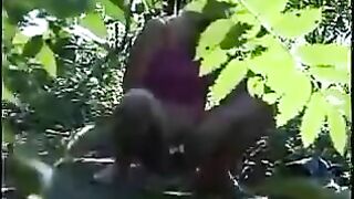 Girl takes a shit on the ground while standing in the woods