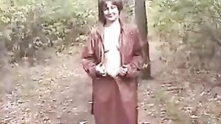Woman pisses in the forest on top of leaves
