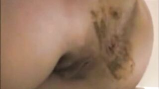 Woman spreads her ass and takes a load of shit