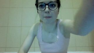 Cute nerdy girl with shaved pussy pissing