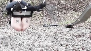 Lady pissing on the swing