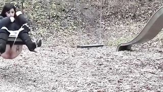 Lady pissing on the swing