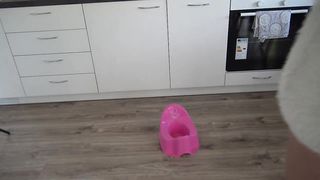 Pretty sexy babe pooping in the potty pot