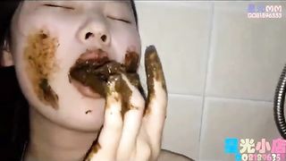 Skinny Asian babe eating her chocolate poop