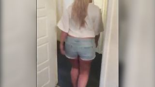 Chubby blonde in shorts pooping in the toilet