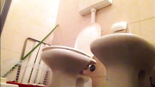 Wife pooping in the toilet at home