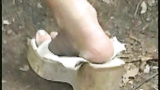 Pretty brunette chick pooping in the jungle