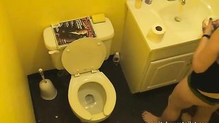 Sexy brunette lady caught pooping in the toilet