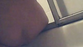 Lady pooping and cleaning in the bathroom